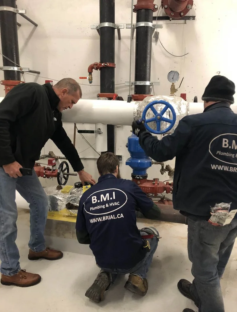 BMI crew exercising a large isolation valve on a condominium heating main