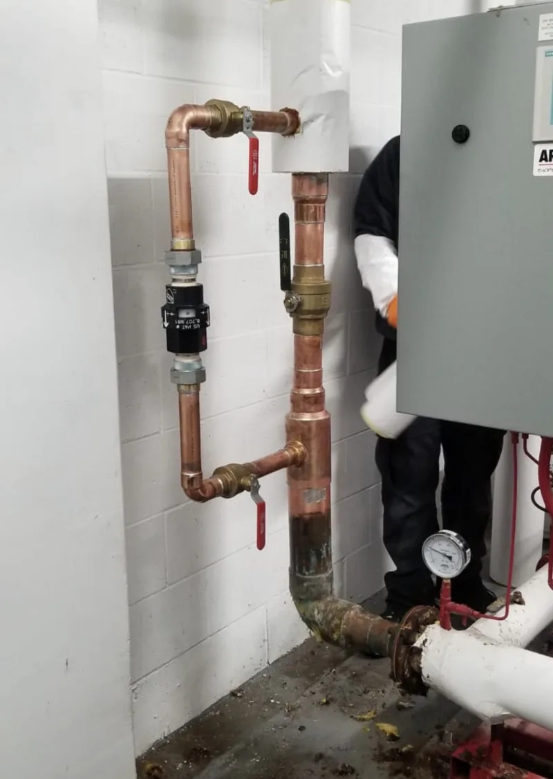 Backflow prevention assembly and isolation valves on copper mains in a Toronto condominium mechanical room serviced by BMI