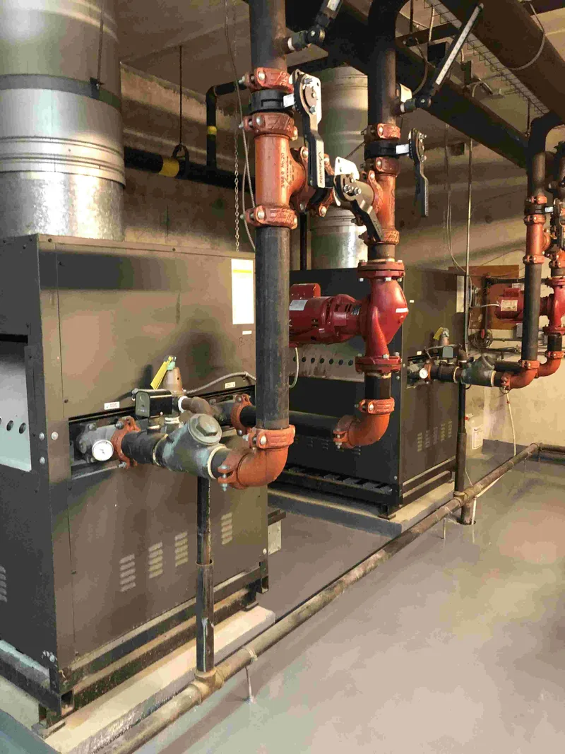 Copper mains and drainage piping in a Toronto condominium mechanical room where BMI carries out camera inspection and condition reporting
