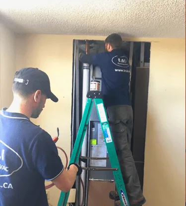 New copper riser pipe being installed in a condominium riser shaft by BMI